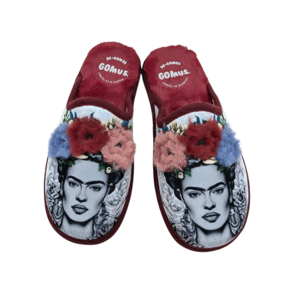 Zapatillas de casa para mujer marca Gomus con estampado artístico e ilustración y pompones de colores sobre fondo blanco.